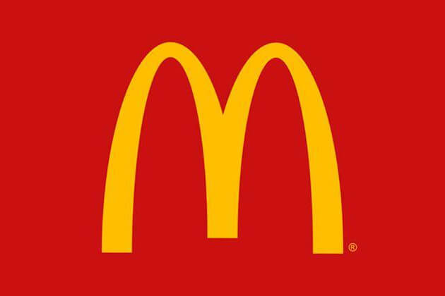 Golden arches on red background, McDonald's logo.