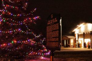 Christmas tree with colorful lights near Highland Station.