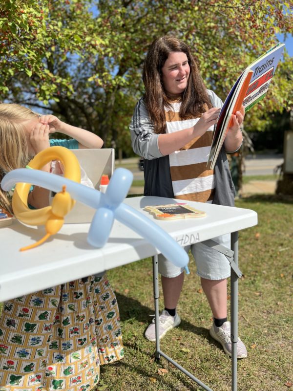 Storytime outdoors with balloons and books.